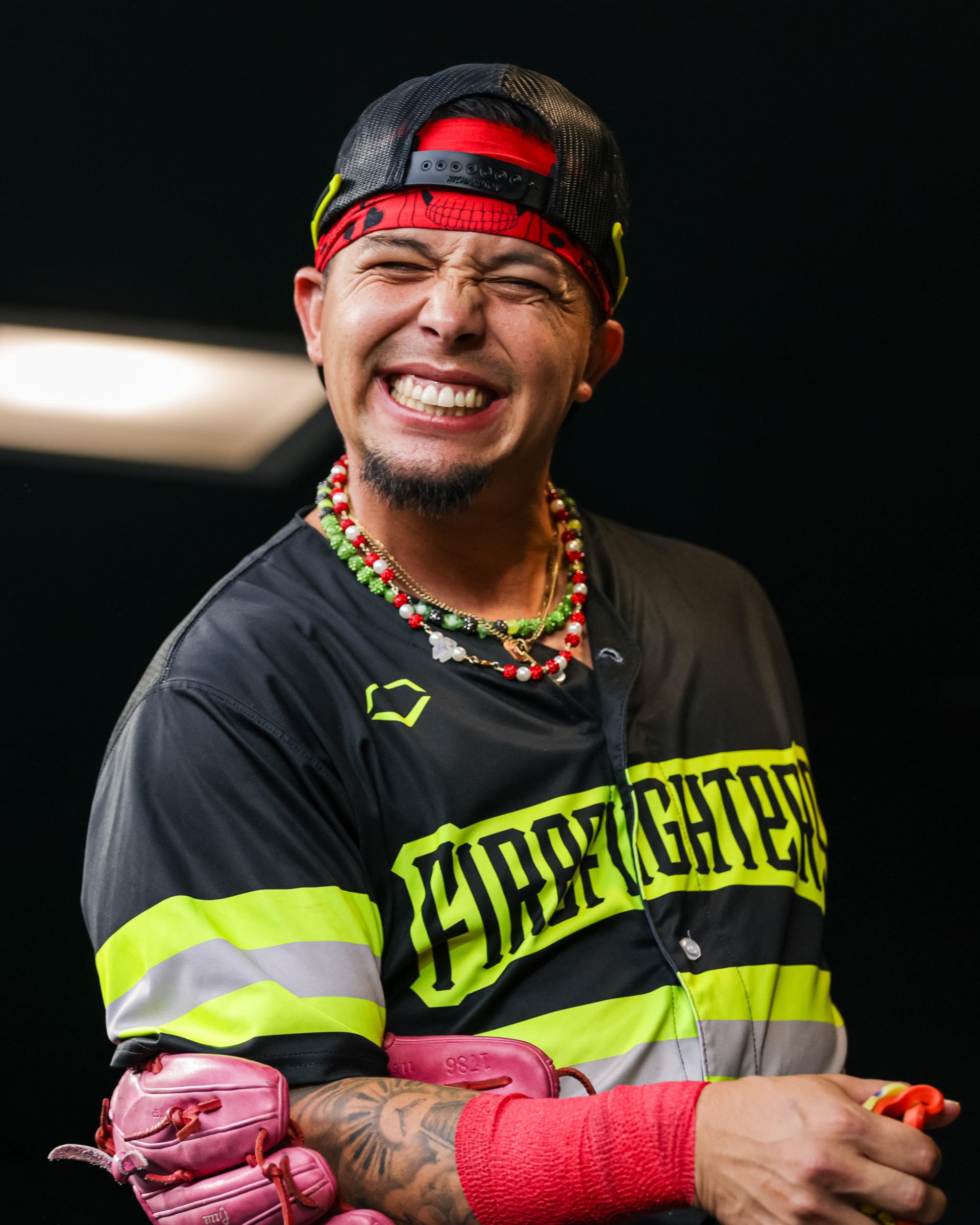 Isaac Parra grinning in his Firefighter baseball uniform. 