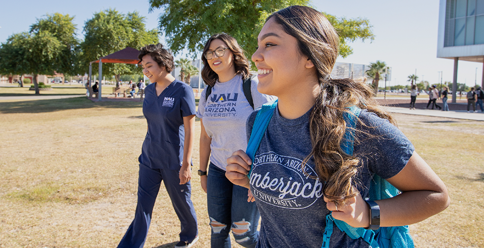 Female students walking across the grass