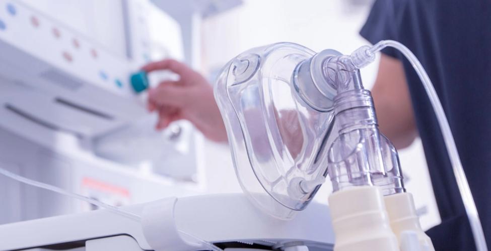 Medical ventilator machine and clear respiratory face mask in a clinical care setting