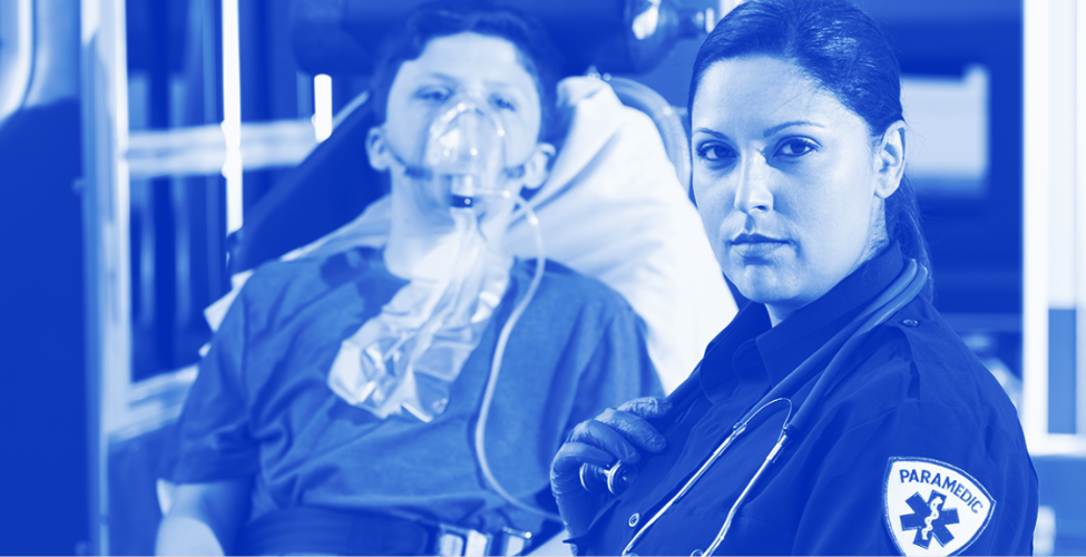 Monochromatic blue image of a female paramedic in uniform caring for a patient wearing an oxygen mask