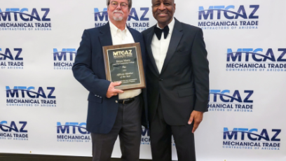 Bruce Martz (left) holding his award.