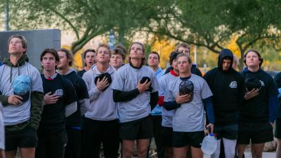GateWay students put their hands over their hearts during the National Anthem before the 2024 Veterans Day Run. 