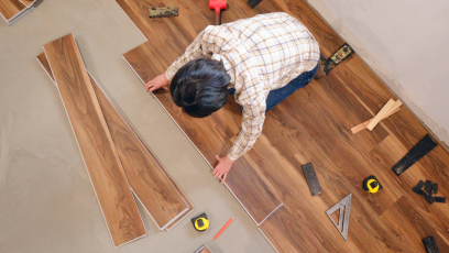 Person works on basic flooring installation with multiple tools