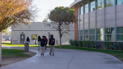 Several students walk through campus on a sidewalk at GateWay
