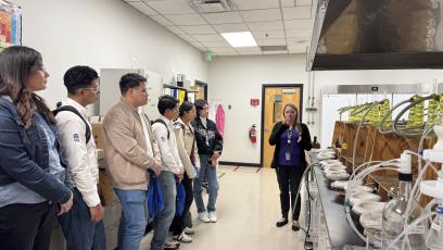 Students from the Universidad de Guanajuato listed to an instructor during their tour of the water utilities labs. 