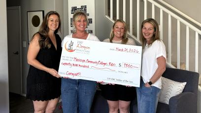 Crissy Haidos, Kara Medlock, Lisha Dunlap, and Katherine Katz from the 100+ Women Who Care Charity hold a large check totaling $7,300 for GateWay. 