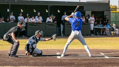 Matt Maize up to bat in a blue jersey in a left-handed batting stance