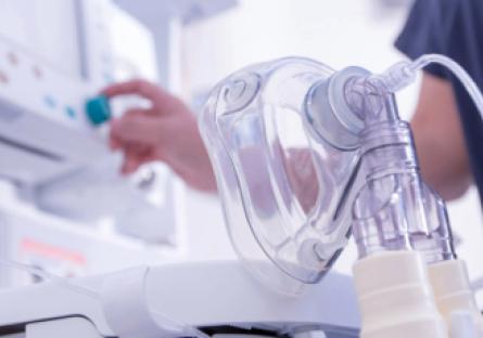 Medical ventilator machine and clear respiratory face mask in a clinical care setting