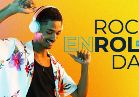 Male wearing floral shirt, and headphones with the words "Rock Enrollment Day"