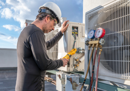 HVAC Technician inspecting an air conditioning unit