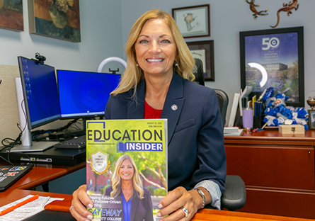 Dr. Amy Diaz smiles with a copy of GateWay on the cover of Education Insider magazine