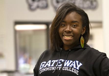 A GateWay Student posing during a past BSU student forum in a black GateWay shirt