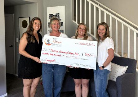 Crissy Haidos, Kara Medlock, Lisha Dunlap, and Katherine Katz from the 100+ Women Who Care Charity hold a large check totaling $7,300 for GateWay. 