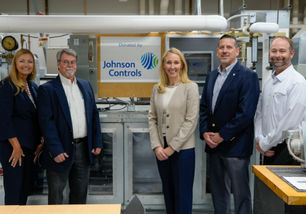 GateWay President Dr. Amy Diaz (far left) and GateWay HVAC Program Director Bruce Martz (middle left) stand with three members of Johnson Control Industries, with a banner reading "Donated by Johnson Controls" hanging in the middle of the group.