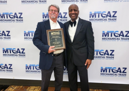 Bruce Martz (left) holding his award.