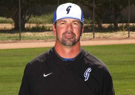 Baseball coach Rob Shabansky poses on a field