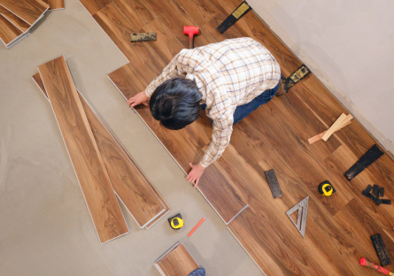 Person works on basic flooring installation with multiple tools