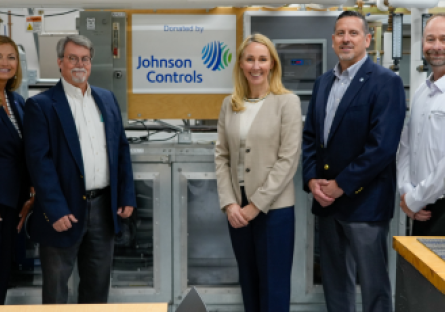 GateWay President Dr. Amy Diaz (far left) and GateWay HVAC Program Director Bruce Martz (middle left) stand with three members of Johnson Control Industries, with a banner reading "Donated by Johnson Controls" hanging in the middle of the group.