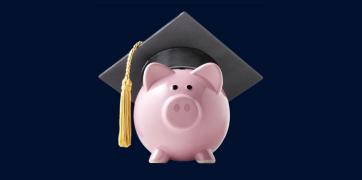 Piggy bank wearing a graduation cap with tassel on a dark blue background, symbolizing saving for education or student financial success.