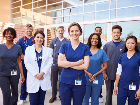Group of healthcare workers standing next to each other 
