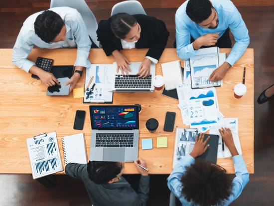 Group of co workers sitting around table