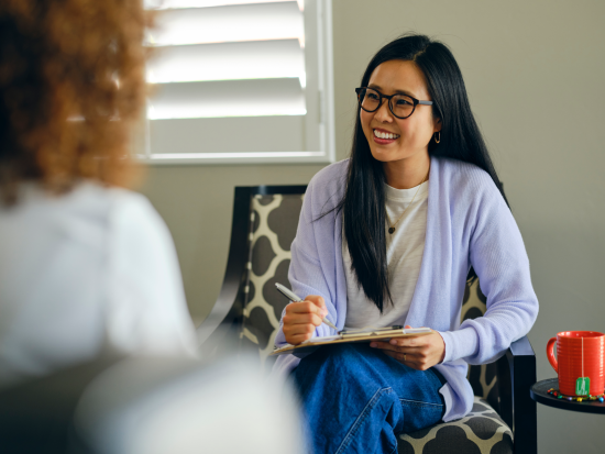 Woman sitting in chair taking notes