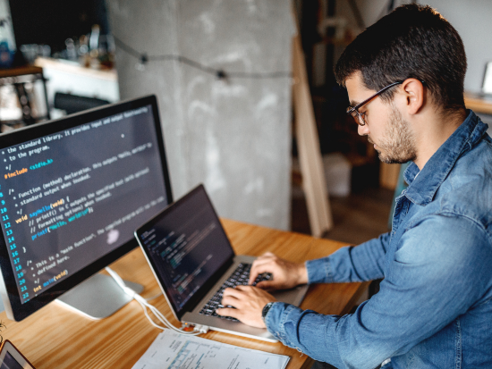 A man coding on a computer