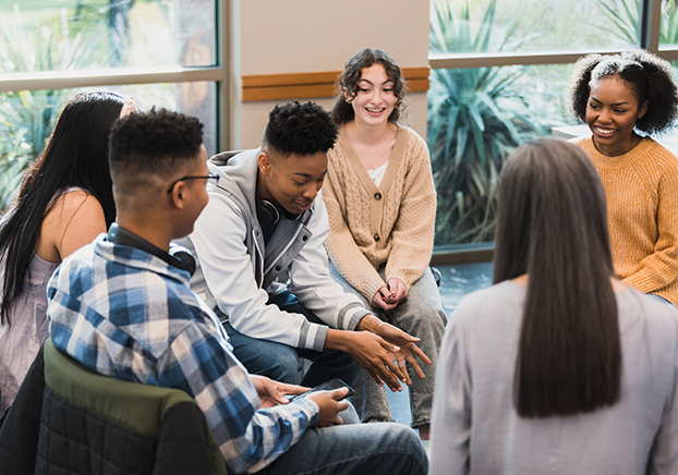 Group of diverse students sitting in a group