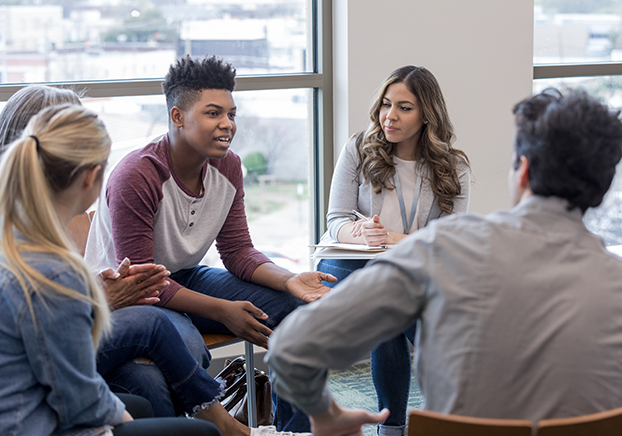 Group of diverse students talking in a circle