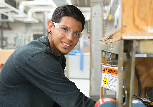 Male HVAC student working on equipment