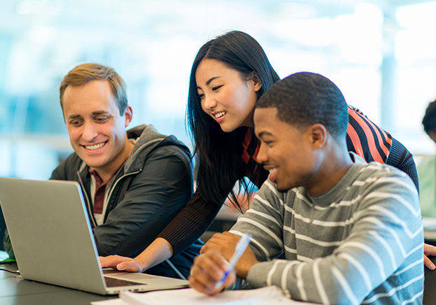 Group of students looking at laptop