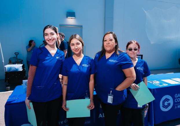GateWay Community College healthcare students in blue scrubs at a campus event.