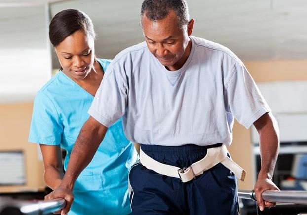 Physical Therapist helping a client on how to walk with balance