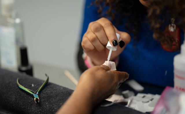 Student performing a professional manicure in a salon lab